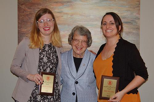 Students with awards posing with an older woman